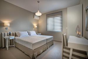 a bedroom with a large bed and a window at Villa Plakias Sunset with Heated Pool & Childrens Area, Walk to Restaurant in Plakias +34 photos
