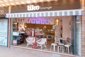 a store window with chairs and tables in it at Hotel Xaine Park in Lloret de Mar