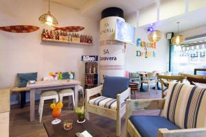 a restaurant with a table and chairs and a dining room at Hotel Xaine Park in Lloret de Mar