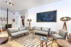 a living room with couches and chairs and a painting at Hotel Xaine Park in Lloret de Mar