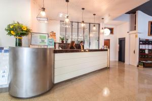 a bar in a restaurant with two people sitting at a counter at Hotel Xaine Park in Lloret de Mar