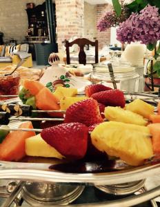 a table topped with plates of fruit and cheese at Maison In Normandie in Saint-Pierre-la-Garenne