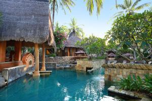a swimming pool in front of a resort at Novotel Lombok Resort & Villas in Kuta Lombok