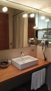 a bathroom with a white sink and a mirror at Mario's Garni in Pescocostanzo