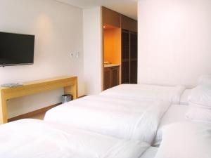 Postel nebo postele na pokoji v ubytování YOUUS Hotel