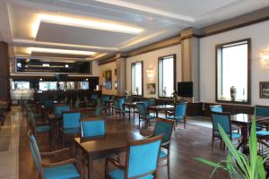 a dining room with tables and chairs and windows at Saylamlar Hotel in Trabzon