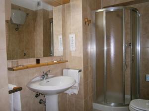 a bathroom with a sink, toilet and shower at Hotel Corona in Termoli