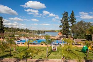 a resort with a large swimming pool and a lake at Hotel Dar Eddaya in Khemisset