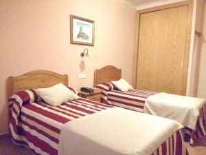 Łóżko lub łóżka w pokoju w obiekcie Hotel Mesón el Castillo