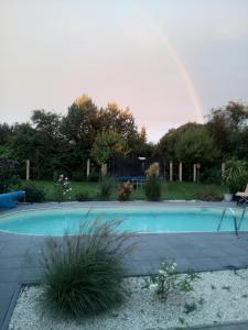 a large swimming pool with a rainbow in the background at Ferienwohnung am Schweriner Außensee in Schwerin
