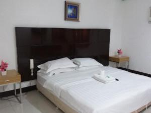 Tempat tidur dalam kamar di Asia Novo Boutique Hotel - Roxas