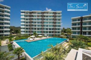 a large apartment building with a large swimming pool at The Sea B36 in Sam Roi Yot