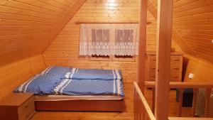 A bed or beds in a room at Chata Terchová - Vyšné Kamence