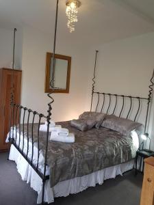 1 dormitorio con 1 cama con marco de metal en The Retreat at Plover Cottage Lindley, en Huddersfield