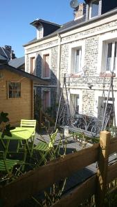a patio with a table and chairs in front of a building at Chez Isa in Yport
