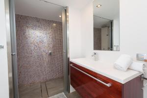 a bathroom with a shower and a white sink at Sa Platja in Playa de Muro +35 photos