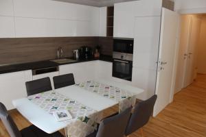 a kitchen with a table and chairs in a room at Park Vienna Hauptbahnhof Apartments in Vienna