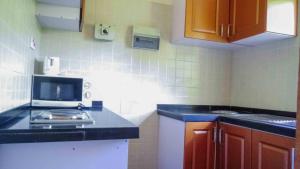 a kitchen with a stove and a counter top at Avon Garden Lodge in Salima