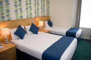 TLH Carlton Hotel - TLH Leisure, Entertainment and Spa Resort客房内的一张或多张床位