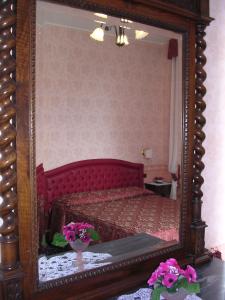 a bedroom with a bed with a large mirror at Villa Fieschi in Lavagna