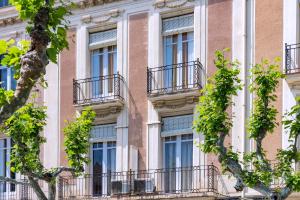 a facade of a building with balconies and trees at Hotel Niza in Salou