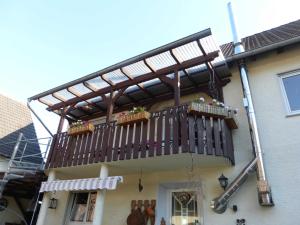 a wooden deck on the side of a house at Ferienwohnung Wendt in Wersau