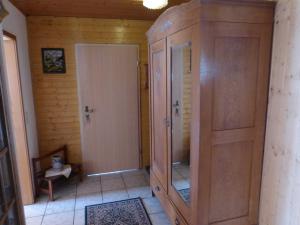 a room with a large wooden cabinet and a door at Ferienwohnung Wendt in Wersau
