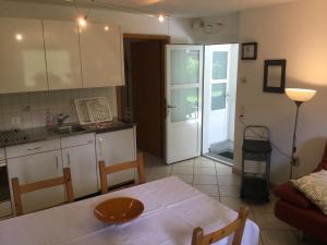 a kitchen with a table and a kitchen with a door at Ca Evelina in Maggia