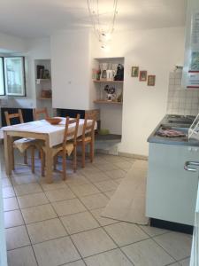 a kitchen with a table and chairs in a room at Ca Evelina in Maggia