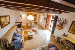 a living room with a couch and a table at Can Cusina in Es Llombards