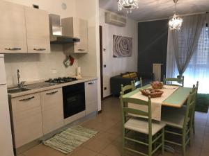 a kitchen with a table and chairs and a refrigerator at Residence Viale Venezia in Verona