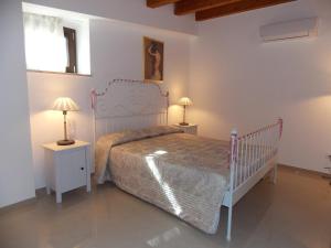 a bedroom with a bed and two night stands with lamps at Residence Ideal in Alcamo