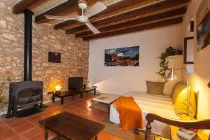 a living room with a couch and a fireplace at Casa Ana in Ses Salines
