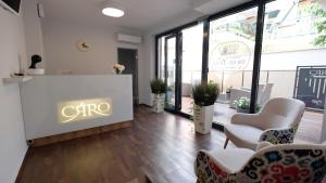 a lobby with chairs and a sign that reads c hr at Caro Apartments & Rooms in Varna City