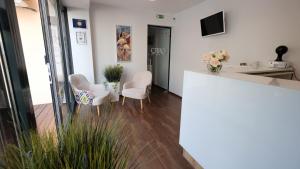 a room with chairs and a table and a counter at Caro Apartments & Rooms in Varna City