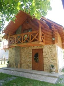 a house with a wooden door and a balcony at Yablunevyi Tsvit in Yaremche