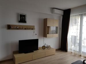 a living room with a flat screen tv on a cabinet at Apartament Ana Navodari Mamaia Nord in Mamaia Nord