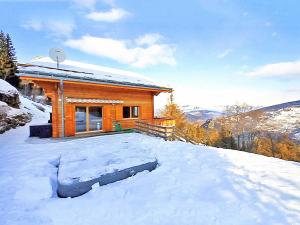 una cabaña de madera en la nieve con mucha nieve en A luxurious 12 person chalet with superb view en Les Collons