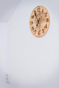 a clock hanging on a white wall next to at ★ 2 minute walk from the Bridge of Lies ★ in Sibiu
