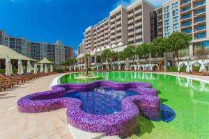 a resort pool with a purple fountain in the middle at Barcelo Royal Beach - All Inclusive in Sunny Beach +93 photos