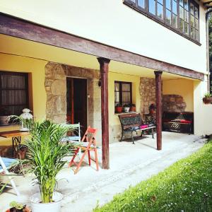 a patio of a house with a table and chairs at Casafer in Naves