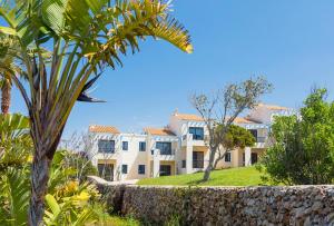 a very nice looking house with lots of trees at Bimbolla Apartaments in Punta Prima