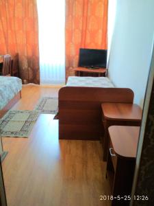 a room with two beds and a laptop on a desk at Hotel Zvenigorod in Zvenigorod