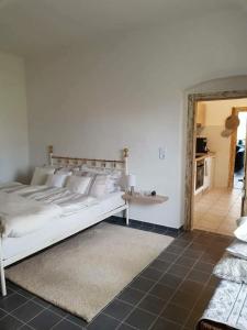 um quarto com uma grande cama branca e uma cozinha em Haus Sissi em Andocs