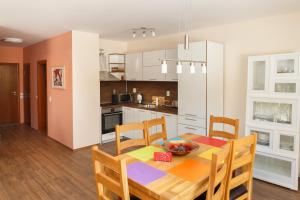 a kitchen and dining room with a table and chairs at Апартамент "Forest view" в комплекс "Вели Хилс" in Velingrad +32 photos
