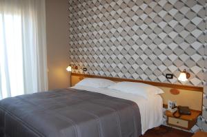 a bedroom with a large bed with a large wall at Hotel Ristorante Donato in Calvizzano