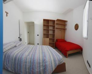 a bedroom with a large bed and a red bench at Apartment Lake Maggiore - ITALIA in Maccagno Superiore