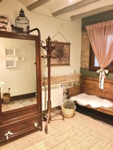 a room with a bed and a mirror and a crib at Apartamento Rural La Serratilla in Alhama de Aragón