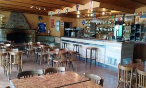 a restaurant with tables and chairs and a bar at Scopa Rossa in Evisa