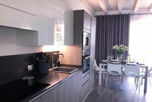 a kitchen with a table and a dining room at Paradise Luxury apartments in Sirmione